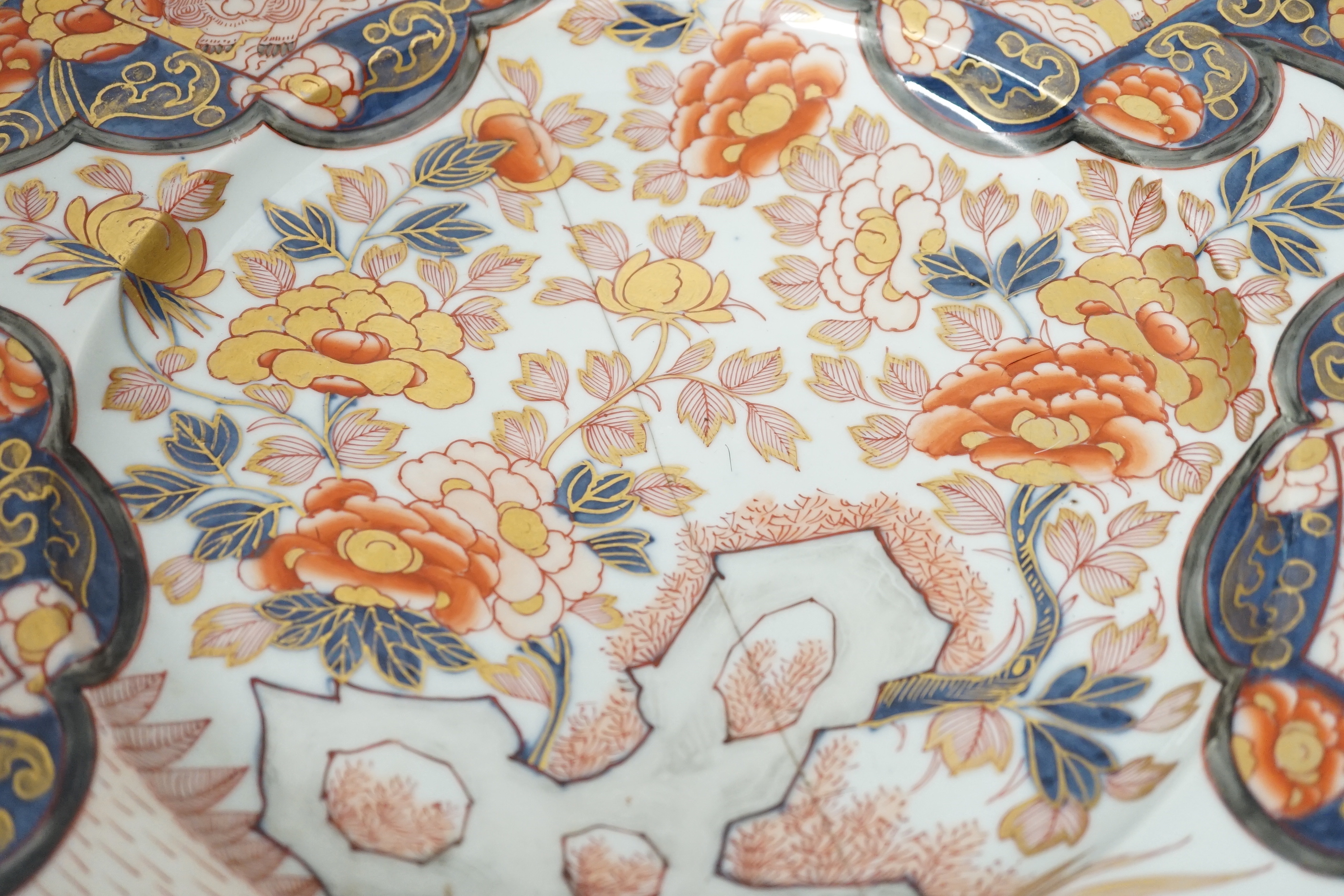 A pair of 19th century Japanese Imari vases, a similar charger, an earlier cracked and riveted charger and a blue and white charger, (5), largest charger 47cm diameter